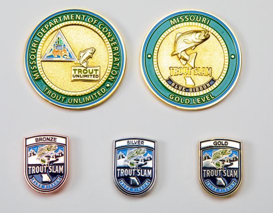 The medallion and gold, silver, and bronze pins awarded to Trout Slam anglers.